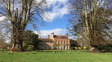 The Old House, Hampshire – Georgian brick house set within mature tree-lined grounds with spring bulbs.