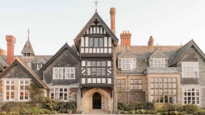 Plas Dinam, Powys – Tudor half-timbered facade with stone wings, tall sash windows, and red-brick chimneys.