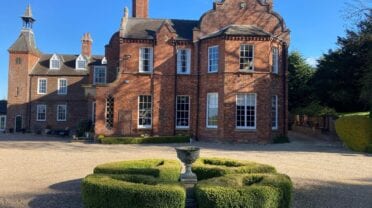 Skendleby Hall, Lincolnshire – Victorian brick country house with formal courtyard, topiary and clock tower.