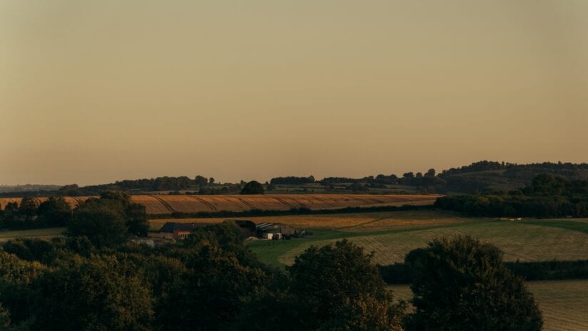 Hyll Hotel, Gloucestershire – Rolling countryside views with agricultural fields and tree-lined horizon from property grounds.