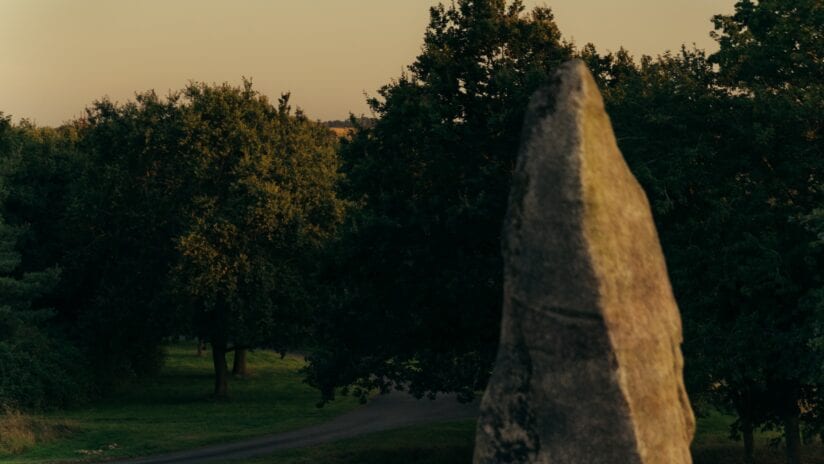 Hyll Hotel, Gloucestershire – Stone monolith on tree-lined driveway at golden hour.