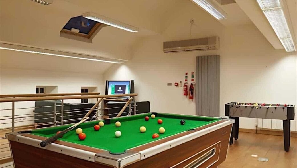Stretton House, Derbyshire – Games room with pool table, foosball table, and mezzanine level.