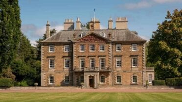 Gilmerton House, East Lothian – Georgian stone mansion with slate roof, tall chimneys and manicured lawn frontage.