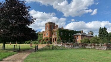 Gunthorpe Hall, Norfolk – Red-brick country house with ivy-covered walls and manicured lawns.