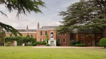 Ingoldisthorpe Hall, Norfolk – Georgian brick country house with formal lawn and mature cedar trees.
