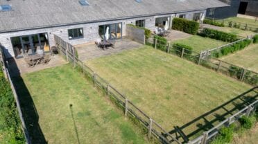 Downlands Farm, Hampshire – Modern barn conversion with patio terrace and expansive paddocked grounds.