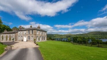 Silverholme Manor, Cumbria – Stone manor house with manicured lawns overlooking lake and wooded valleys.